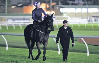  ?? PHOTO: GETTY IMAGES ?? Racing royalty . . . Winx’s jockey, Hugh Bowman, and trainer Chris Waller chat as they walk along the Rosehill track where the champion mare worked yesterday morning. Winx will contest the George Ryder Stakes there tomorrow.