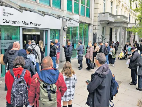  ?? ?? Long queues outside HM Passport Office in London. A union has blamed processing delays on the inability to recruit sufficient permanent staff to meet the soaring demand