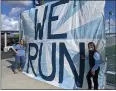  ?? ?? Students set up large posters, saying “We Run This School” on Friday at the front of Pleasant Valley High School.