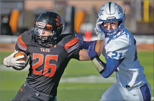  ?? Morgan Timms ?? Taos’ senior running back Jonathan Garcia holds off Lovington’s Ayden Garcia on Saturday (Nov. 17) during the Tigers’ 55-7 victory against the Wildcats at Anaya Stadium.