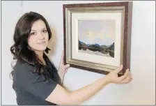  ?? PNG ?? Kate Bellringer shows an untitled Tom Thomson oil on plywood painting
at Maynard’s Auctions in Vancouver on Thursday.