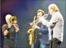  ??  ?? Performing on stage Tuesday are, from left, trombonist James Pankow, woodwind player Walter Parazaider, and trumpeter Lee Loughnane, all founding members of Chicago.