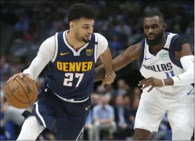  ?? RON JENKINS - THE ASSOCIATED PRESS ?? Denver Nuggets guard Jamal Murray (27) handles the ball as Dallas Mavericks guard Tim Hardaway Jr. (11) defends during the first half of an NBA basketball game Wednesday, March 11, 2020, in Dallas.