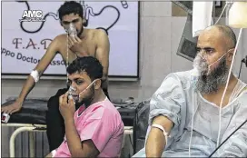  ?? ALEPPO MEDIA CENTER / VIA ASSOCIATED PRESS 2016 ?? Men breathe with oxygen masks in September inside a hospital in Aleppo, Syria, following an apparent chlorine gas attack on a rebel-controlled neighborho­od. A rights group alleges eight more attacks late last year.