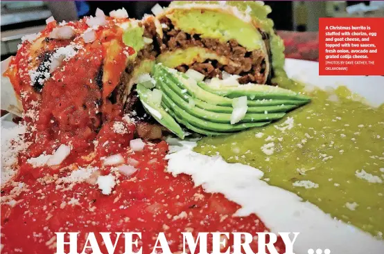  ?? [PHOTOS BY DAVE CATHEY, THE OKLAHOMAN] ?? A Christmas burrito is stuffed with chorizo, egg and goat cheese, and topped with two sauces, fresh onion, avocado and grated cotija cheese.