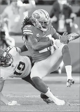  ?? SEAN M. HAFFEY/GETTY-AFP ?? The 49ers’ Richard Sherman intercepts a pass against the Vikings in the third quarter Saturday.