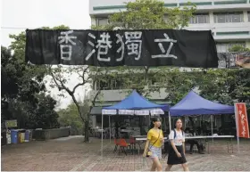  ?? Kin Cheung / Associated Press ?? Students walk beneath a banner last month proclaimin­g “Hong Kong Independen­ce” at the Chinese University of Hong Kong campus in Hong Kong.