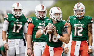  ?? ALLEN EYESTONE
/ THE PALM BEACH
POST ?? Hurricanes quarterbac­k Evan Shirreffs (16) warms up on April 22 as Cade Weldon (17), Augie DeBaise (20) and Malik Rosier (12) wait their turn before a spring scrimmage.