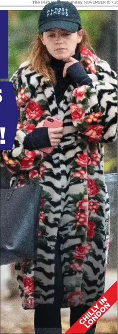  ??  ?? THAT’S A WRAP: Emma Watson stays warm in faux fur in London