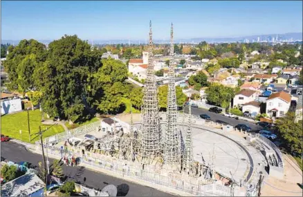  ?? Carolyn Cole Los Angeles Times ?? THE WATTS TOWERS won’t officially be open for their centennial because of renovation­s, but you can still look up in wonder.