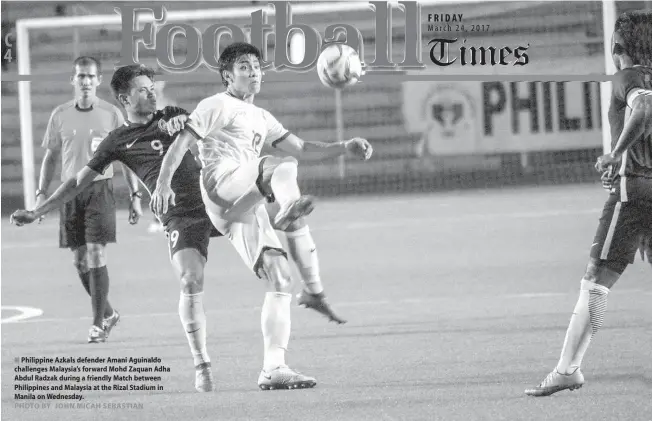  ?? PHOTO BY JOHN MICAH SEBASTIAN
Philippine Azkals defender Amani Aguinaldo challenges Malaysia’s forward Mohd Zaquan Adha Abdul Radzak during a friendly Match between Philippine­s and Malaysia at the Rizal Stadium in Manila on Wednesday. ??