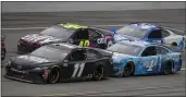  ?? JOHN BAZEMORE — THE ASSOCIATED PRESS FILE ?? Denny Hamlin (11) takes the inside lane in front of Kevin Harvick (4) as Jimmie Johnson (48) keeps up during a NASCAR Cup Series auto race at Talladega Superspeed­way in Talladega Ala., on June 22, 2020.