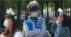  ?? Sam McNeil/Associated Press ?? Visitors wearing face masks wait to enter Shanghai Disneyland on Monday.