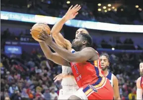  ?? GERALD HERBERT AP ?? Pelicans forward Zion Williamson, who scored a season-high 36 points, goes to the basket against Timberwolv­es center Rudy Gobert in the first half Monday in New Orleans.