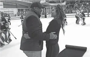  ?? ADAM CAIRNS/COLUMBUS DISPATCH ?? Ohio State athletic director Gene Smith hugs women’s hockey coach Nadine Muzerall after a win over St. Thomas on Feb. 17.