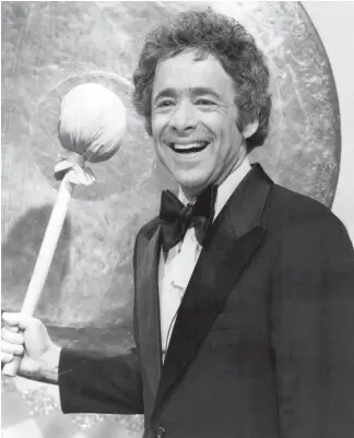  ?? File photo ?? In this June 1976 photo promoting the debut of “The Gong Show,” Chuck Barris is pictured near the famous gong which was used to abruptly end an act which one of the three judges considered poor. Barris died Tuesday at the age of 87.