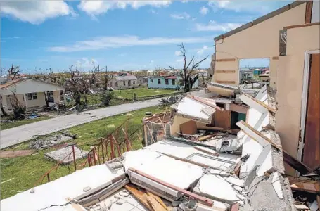  ?? Jose Jimenez Getty Images ?? THE TOWN of Codrington on Barbuda last month. Barbudans fear losing communal land to foreigners if individual ownership is allowed.
