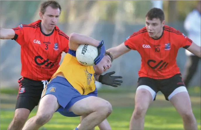  ??  ?? Declan Byrne, St. Mochtas loses his footing but keeps possession as Terry Donegan and Sean Gilsenan challenge for Mattock Rangers. Picture: Ken Finegan