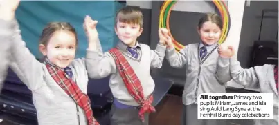  ??  ?? All together Primary two pupils Miriam, James and Isla sing Auld Lang Syne at the Fernhill Burns day celebratio­ns
