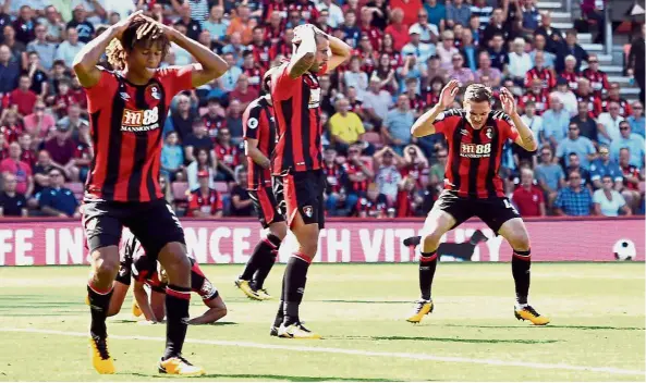  ??  ?? Up in arms: Bournemout­h players look dejected after Manchester City scored their second goal on Saturday. — Reuters