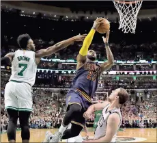  ?? Charles Krupa / The Associated Press ?? Cleveland’s LeBron James (23) drives between Boston’s Jaylen Brown (7) and Kelly Olynyk during the first quarter of Game 1 in the Eastern Conference finals.