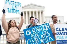  ?? AP ?? Supporters of the Clean Water Act demonstrat­e outside the Supreme Court on Oct. 3, 2022. The court on May 25 made it harder for the federal government to police water pollution in a decision that strips protection­s from wetlands that are isolated from larger bodies of water.