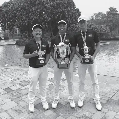  ??  ?? LUIS CASTRO (center) holds his huge trophy as he poses with Sean Ramos (left) and Gab Manotoc after they swept the individual and team championsh­ips in the Indonesia Amateur Open.