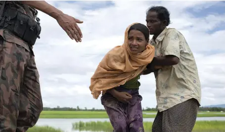  ??  ?? A Rohingya woman trying to reach a refugee camp in no-man’s land on the Bangladesh-Myanmar border Antolin Avezuela for The National