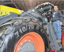  ?? TERRENCE MCEACHERN/THE GUARDIAN ?? Wayne Visser of Allan Equipment Manufactur­ing Ltd. stands on a Claas farm tractor.