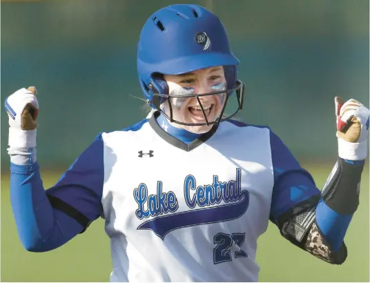  ?? JOHN SMIERCIAK/POST-TRIBUNE ?? Lake Central’s Katie O’Drobinak celebrates as she approaches home plate after hitting a home run against Crown Point during a game in St. John on Wednesday.