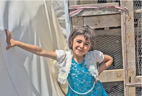  ??  ?? Hanzad Morat, above, in a refugee camp in Duhok. Joman Khalaf, below, and with her brothers Raad and Akram, above left, has been left traumatise­d