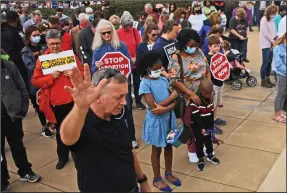  ?? (Arkansas Democrat-Gazette/Staci Vandagriff) ?? People attending the March for Life rally join in prayer Sunday at the state Capitol in Little Rock.