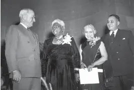  ?? HARVEY GEORGES AP ?? President Harry S. Truman poses with Mary McLeod Bethune, Madame Vijaya Lakshmi Pandit, and Dr. Ralph Bunche in Washington on Nov. 15, 1949. They were presented with citations for outstandin­g citizenshi­p. Bethune founded the National Council of Negro Women, worked with President Franklin Roosevelt to create the Federal Council on Colored Affairs, also known as the Black Cabinet, and was part of a U.S. delegation that created the United Nations charter.