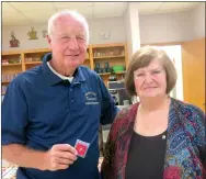  ?? Westside Eagle Observer/SUSAN HOLLAND ?? Kim Hendren wears a charter member shirt and displays a Kiwanis pin to wear on it given him by Dan Yates at the Gravette Kiwanis Club installati­on banquet Monday, Sept. 24. Lavon Stark (pictured with Hendren) outgoing president, presented him the shirt recognizin­g him as the Gravette club’s only surviving charter member.