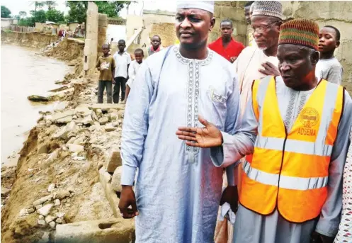  ?? PHOTO ?? Executive Secretary, Adamawa State Emergency Management Agency, Mr Haruna Furo (right) with a member Adamawa State House of Assembly, representi­ng Mubi North LGA, Mr Sani Shehu, assess the damage caused by flood at Shuwari Ward in Mubi yesterday. NAN