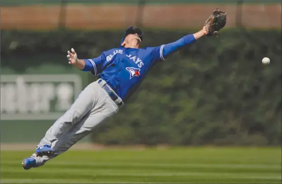  ?? The Associated Press ?? Toronto Blue Jays second baseman Darwin Barney misses an RBI single hit by Chicago Cubs’ Albert Almora Jr. during the second inning of Friday’s game at Wrigley Field in Chicago.