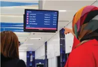  ?? — SUPPLIED PHOTO ?? Passengers check out the digital screen showing metro train informatio­n.