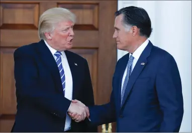  ?? AP FILE PHOTO BY CAROLYN KASTER ?? Then-president-elect Donald Trump and Mitt Romney shake hands Nov. 19, 2016 as Romney leaves Trump National Golf Club Bedminster in Bedminster, N.J.