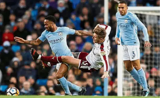  ??  ?? Out of my way!: Manchester City’s Raheem Sterling (left) vying for the ball with Burnley’s Jeff Hendrick in the English FA Cup third round match at the Etihad on Saturday. City won 4-1. — Reuters