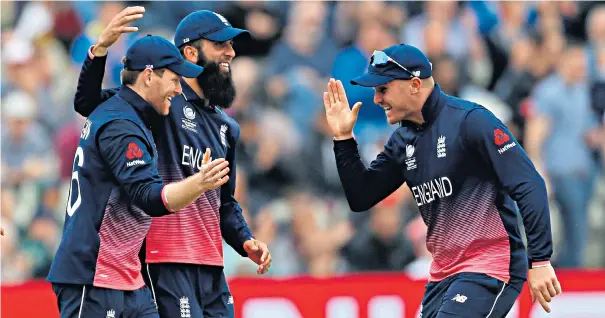  ??  ?? Farewell party: Eoin Morgan (left) and Moeen Ali celebrate a wicket with Jason Roy – but Roy has failed with the bat for three games in succession