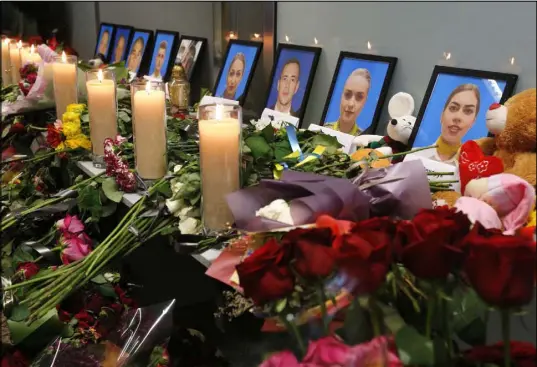  ?? Efrem Lukatsky The Associated Press ?? Flowers and candles are placed in front of portraits of the flight crew members of the Ukrainian 737-800 plane that crashed on the outskirts of Tehran, at a memorial inside Boryspil Internatio­nal Airport outside Kyiv, Ukraine, Saturday.