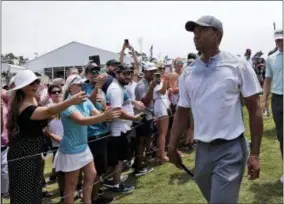  ?? LYNNE SLADKY — THE ASSOCIATED PRESS ?? Tiger Woods walks off the 18th hole during the third round of the Players Championsh­ip golf tournament, Saturday in Ponte Vedra Beach, Fla.