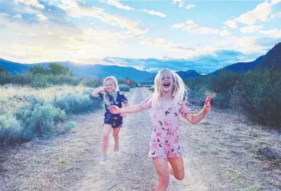  ?? PHOTOS: CHRISTIE GRAHAM ?? The writer's daughters enjoy fresh air and open skies on a family RV expedition.