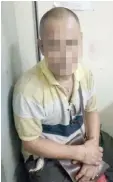  ??  ?? The suspect in detention at Kuching Central police station.