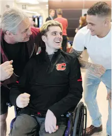  ?? LEAH HENNEL ?? Humboldt Broncos hockey player Ryan Straschnit­zki shares a laugh with WWE legend Bret Hart, left, and UFC fighter Dustin Poirier Wednesday at the Foothills Medical Centre.