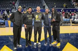  ?? Paul Sancya/Associated Press ?? Former Michigan Fab Five basketball players Chris Webber, from left, Jalen Rose, Michigan head coach Juwan Howard, Jimmy King and Ray Jackson pose after a college basketball game against Ohio State Monday in Ann Arbor, Mich.