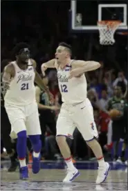  ?? MATT SLOCUM — THE ASSOCIATED PRESS ?? The 76ers’ T.J. McConnell (12) and Joel Embiid celebrate during Game 4 of a second-round playoff series against the Celtics May 7 in Philadelph­ia.