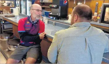  ?? Noam N. Levey Los Angeles Times ?? DR. PAUL GORDON talks with a railroad worker at a diner in Forsyth, Mont. He was shocked by the lack of empathy he heard when discussing healthcare, but now feels inspired to explain how the system works.