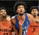  ?? IMAGES STEVE DYKES / GETTY ?? Duke freshman Marvin Bagley III (center) had a big weekend in Oregon to help keep the Blue Devils atop the AP Top 25 poll.