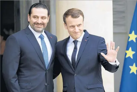  ?? Bertrand Guay AFP/Getty Images ?? SAAD HARIRI, left, lauded French President Emmanuel Macron for his support, saying that he had shown “an infallible friendship and I will never forget this.” The visit was meant to dispel speculatio­n that Hariri was being held hostage in the Saudi...